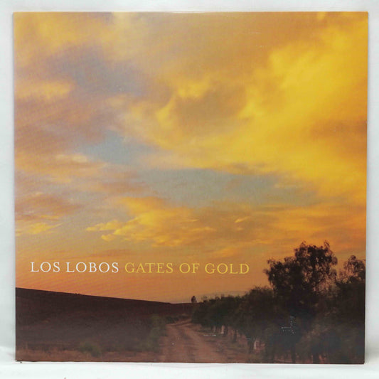 Vinyl record cover for 'Gates of Gold' by Los Lobos with a sunset landscape.