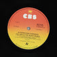 Record label with CBS logo and album details on a black background